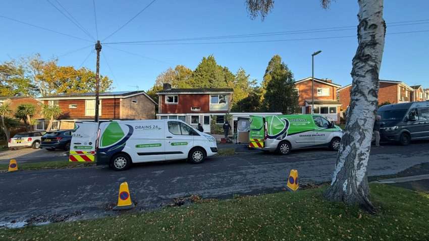 Homeowner performing winter drain maintenance in Salisbury to prevent blockages and flooding.